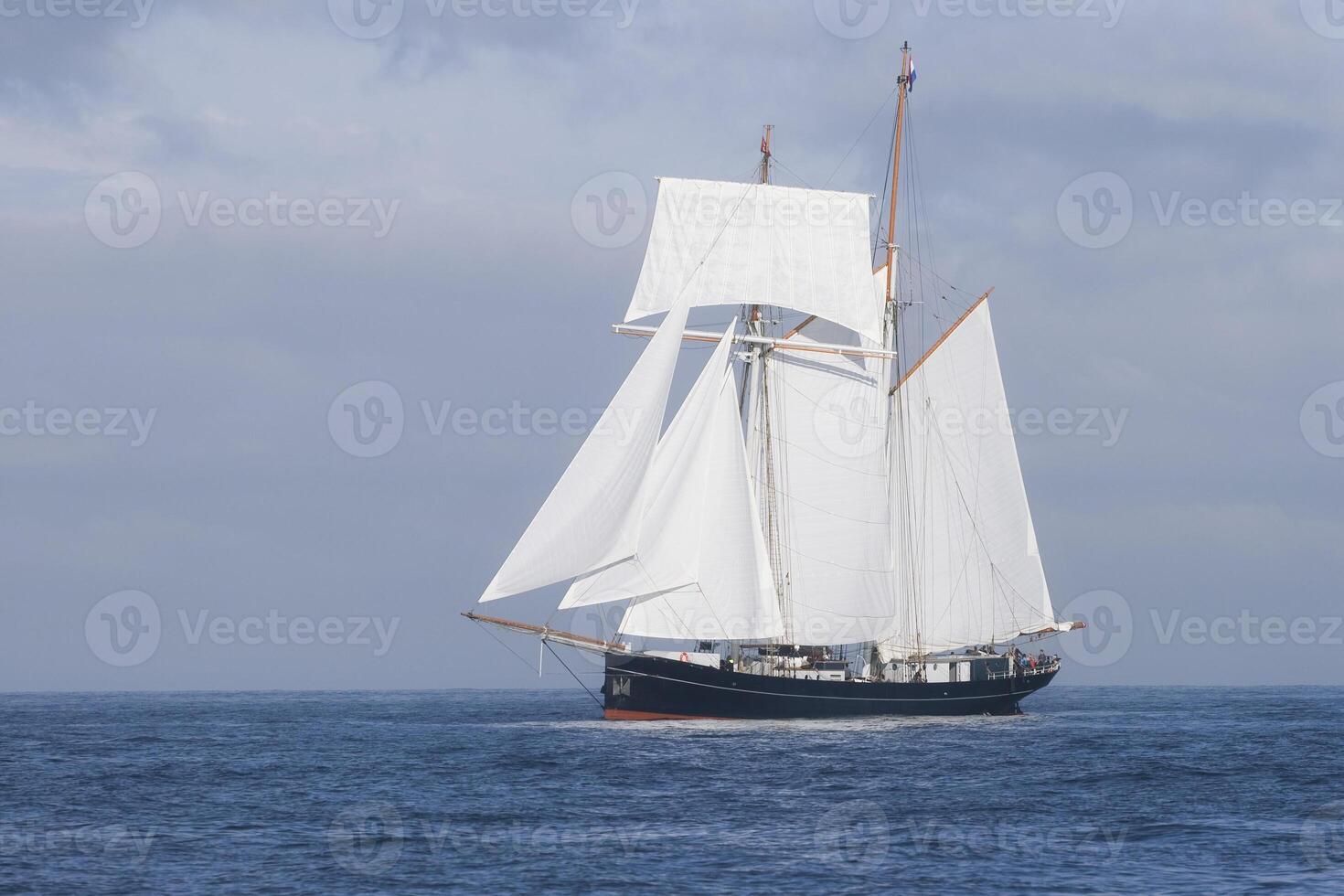 Tall ship sailing in the sea photo