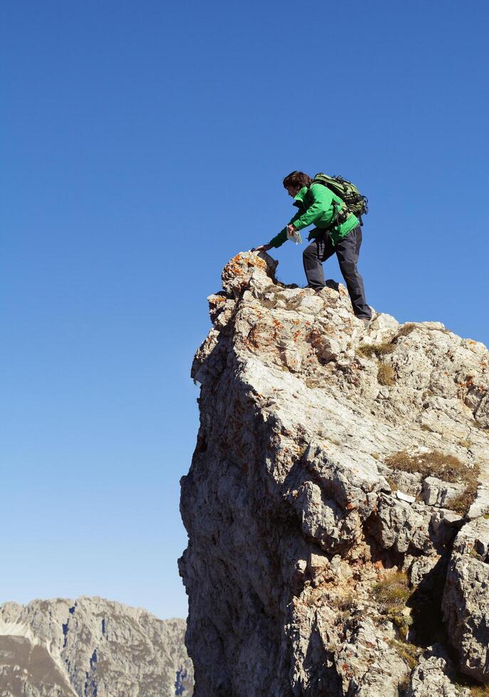 Tourist standing on a cliff photo