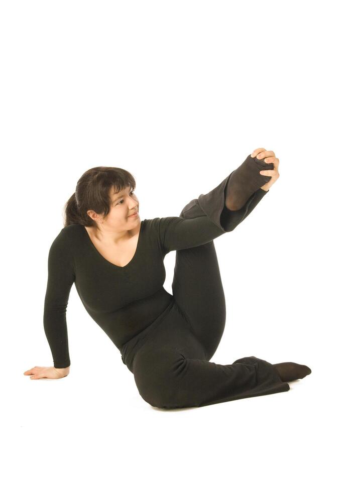 Exercising woman sitting on the floor photo