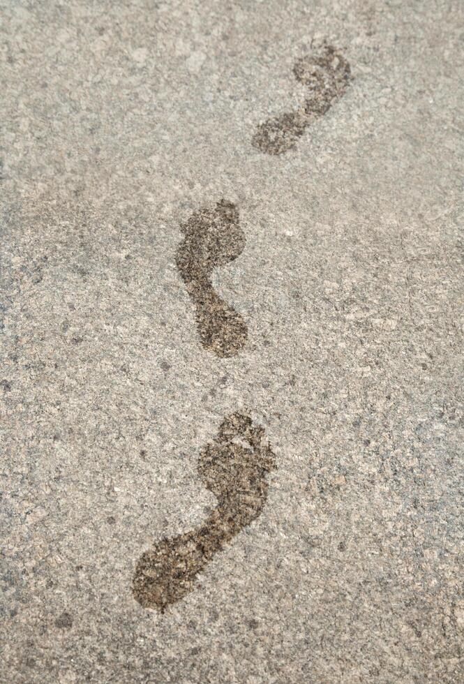 Wet footprints on granite photo