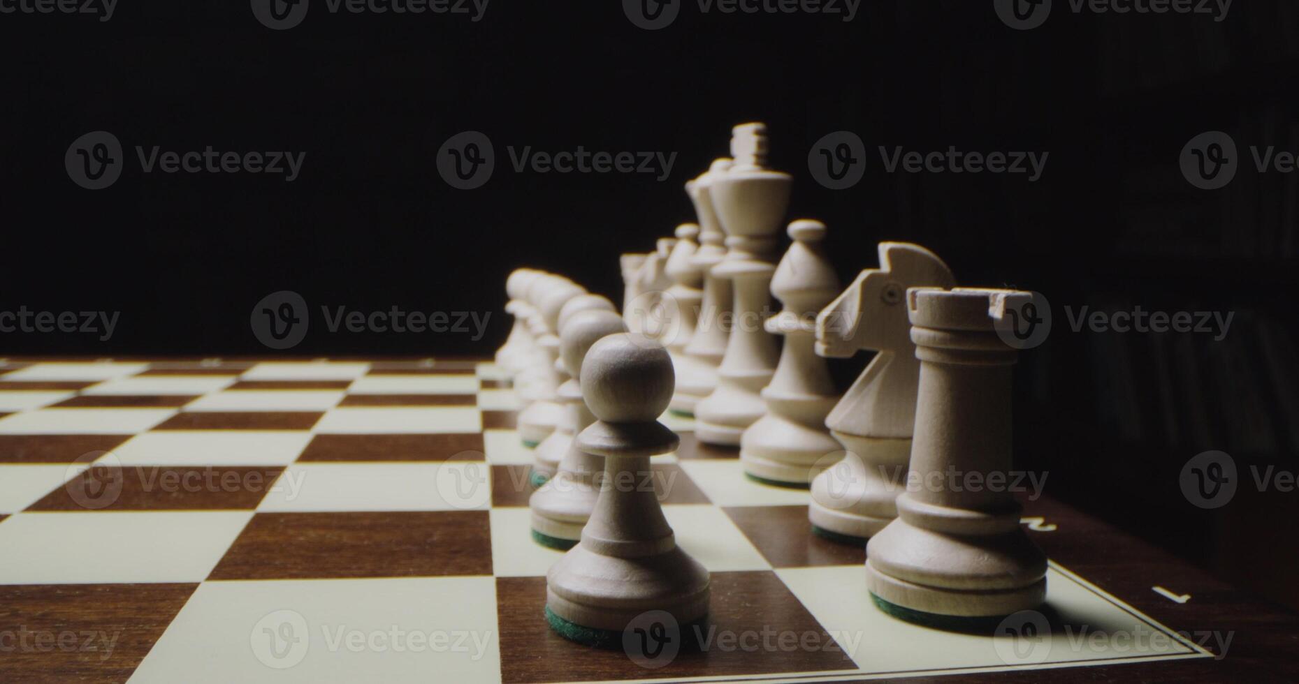 White chess pieces are lined up in rows on a game board, ready for a chess game, close up photo