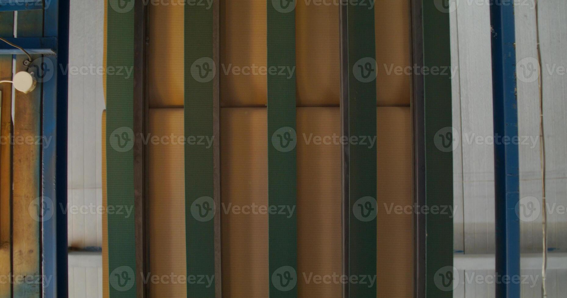 A paper factory. Corrugated cardboard moving on the machine, close up, top view photo