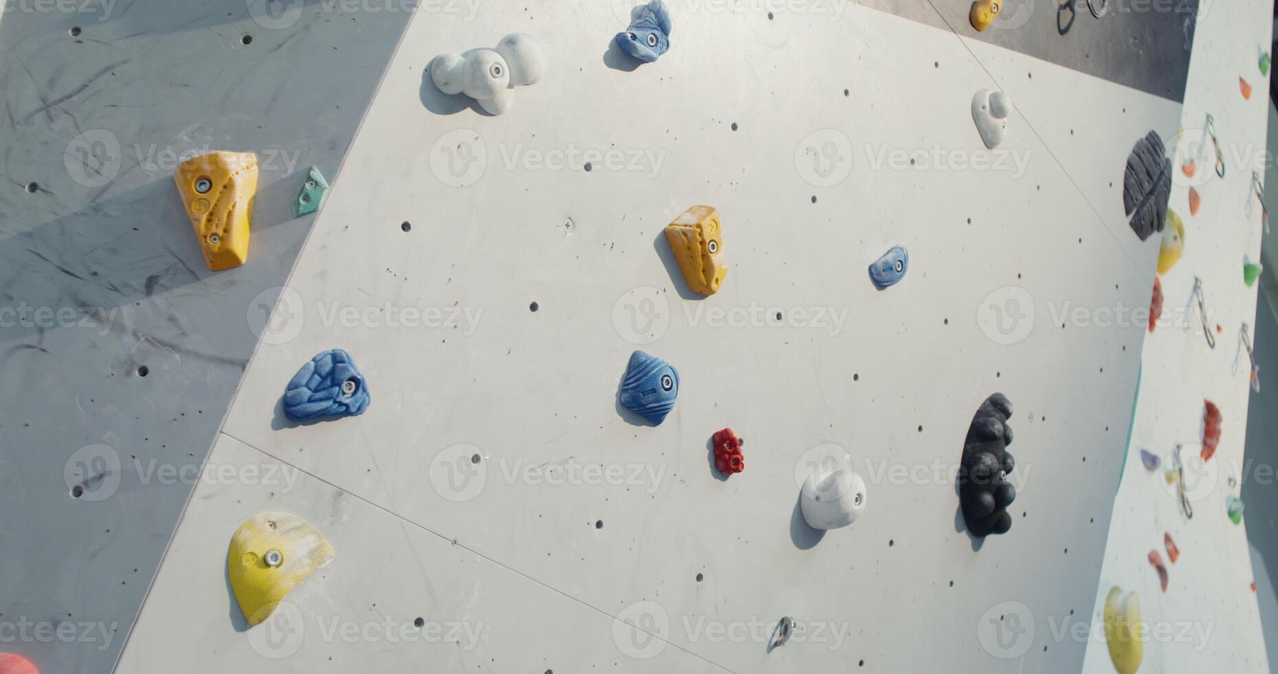 Shooting a Rock Climbing Wall with many irregularities and angles that simulate rocks and ledges, close up without people. photo