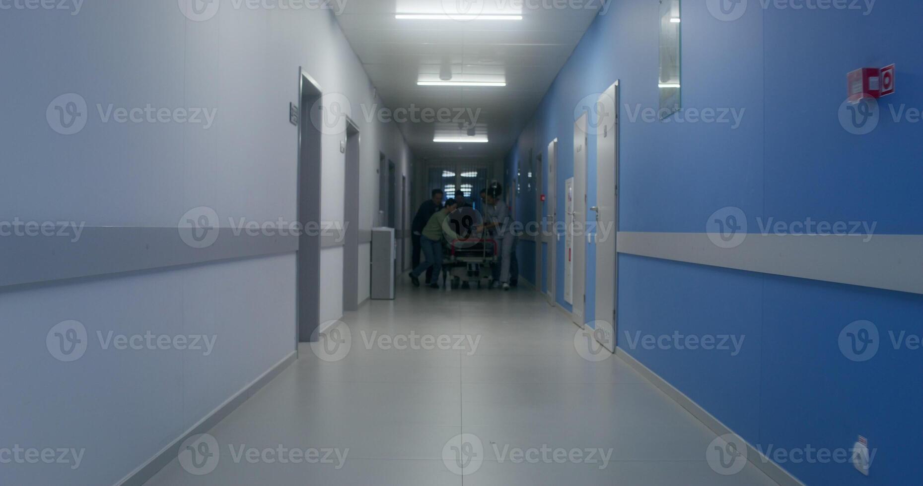 Medical staff and relatives of the victim are running down the hospital corridor carrying the patient on a gurney - victim photo