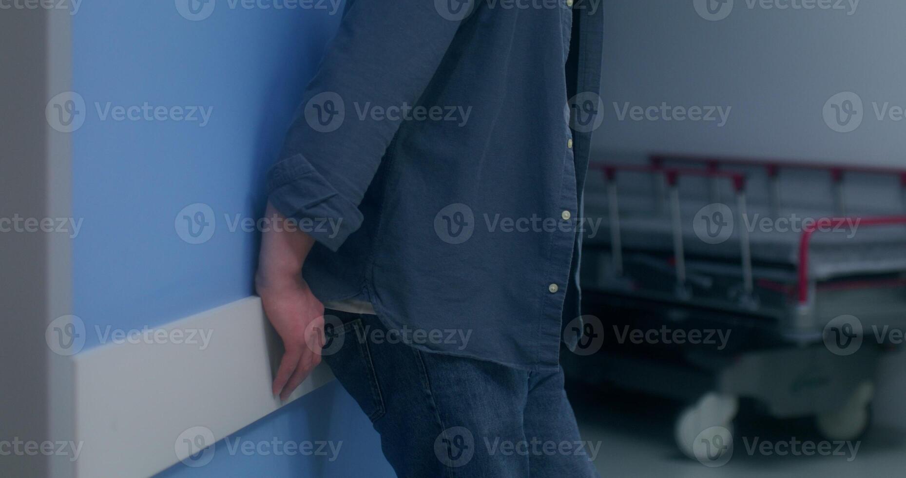The nervous man standing in the hospital corridor and waiting for the result of the operation photo