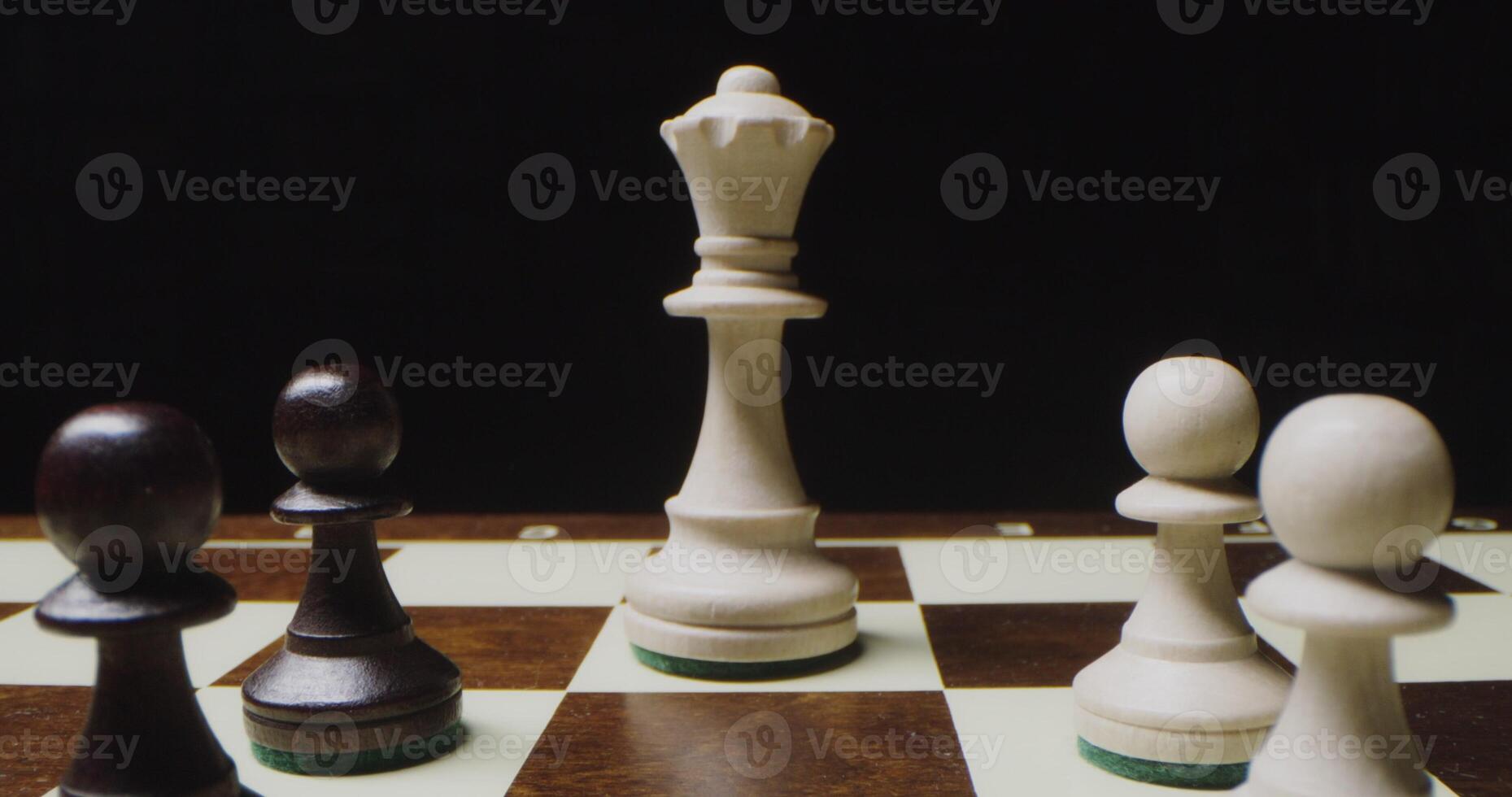 Chess stand in even rows on the game board. Pawns lined up in front of the king photo