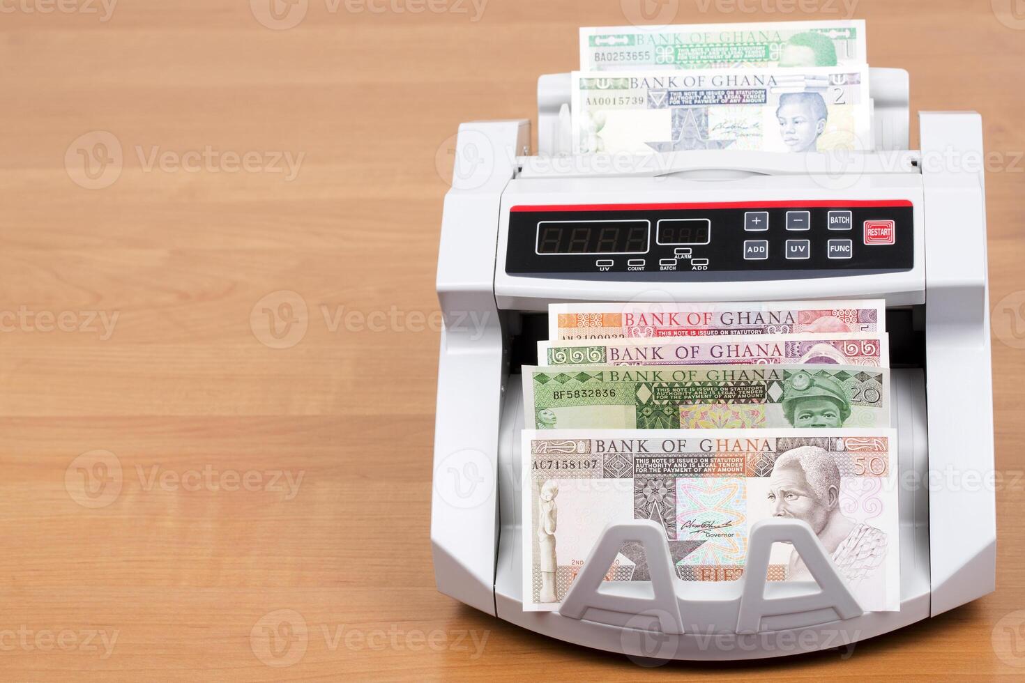 Old Ghanaian cedi in the counting machine photo