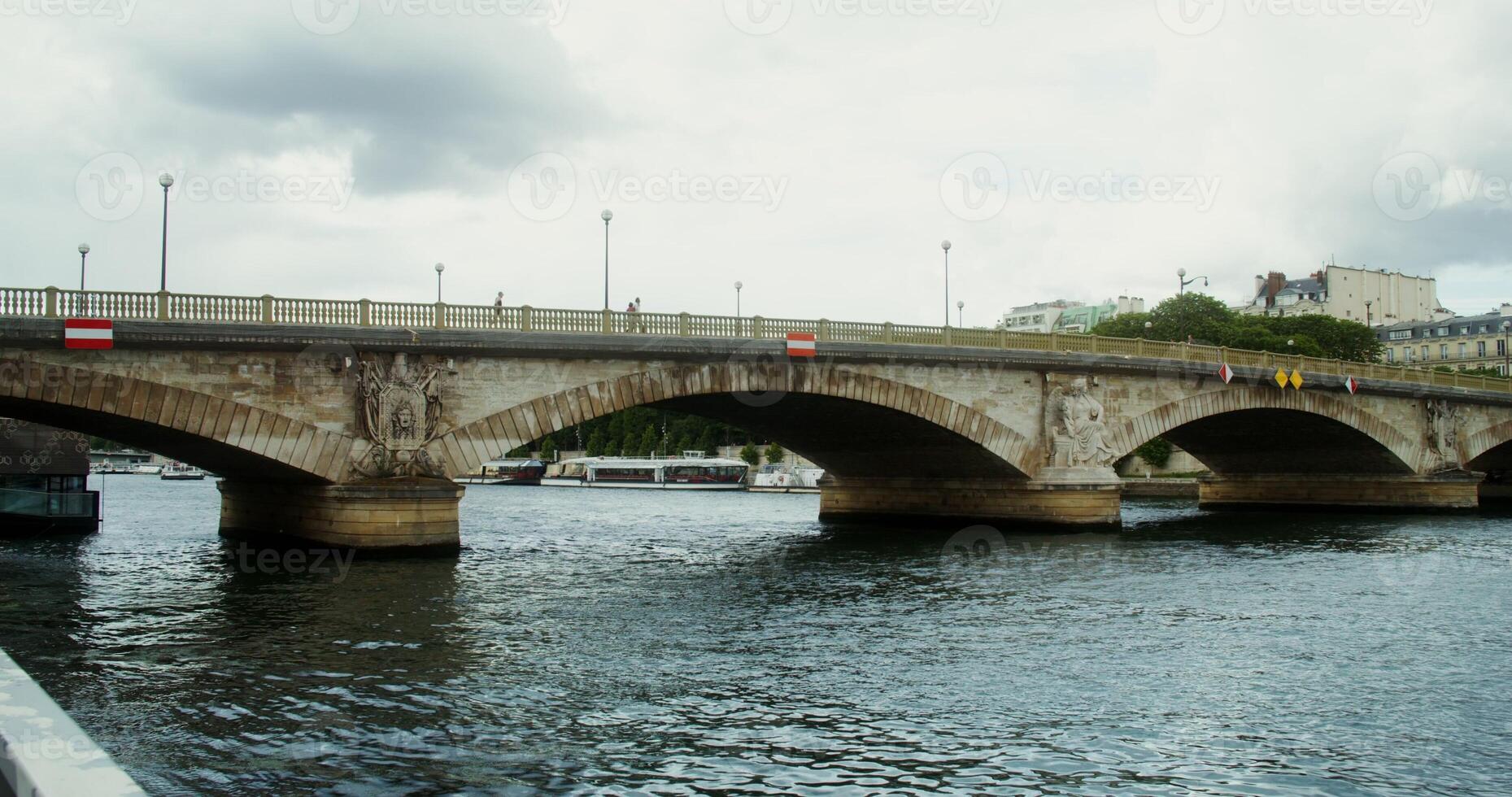 Panoramic view of concrete bridge across the Seine. Motor ships and yachts are moored along the embankment. Paris, France. 4k , red komodo photo