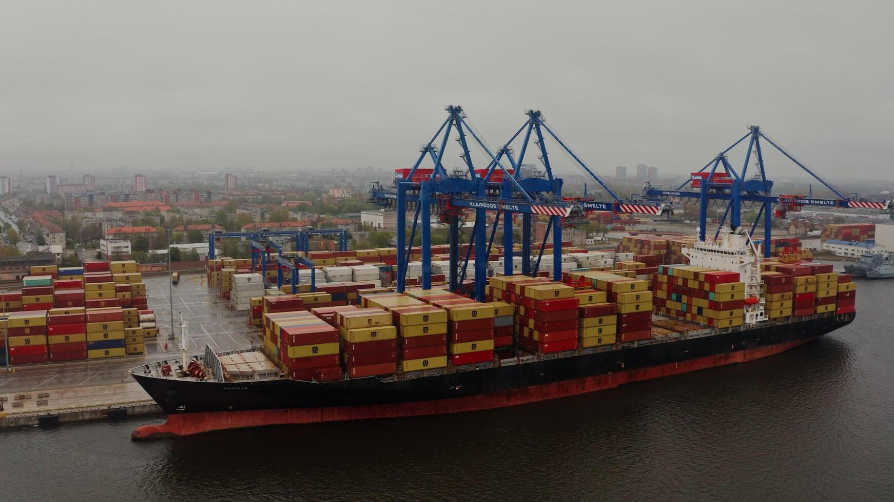 Port of Klaipeda, Lithuania, 2025 - Barge loaded with containers for international shipping, moored in an industrial port, Klaipeda, Lithuania. Drone . photo