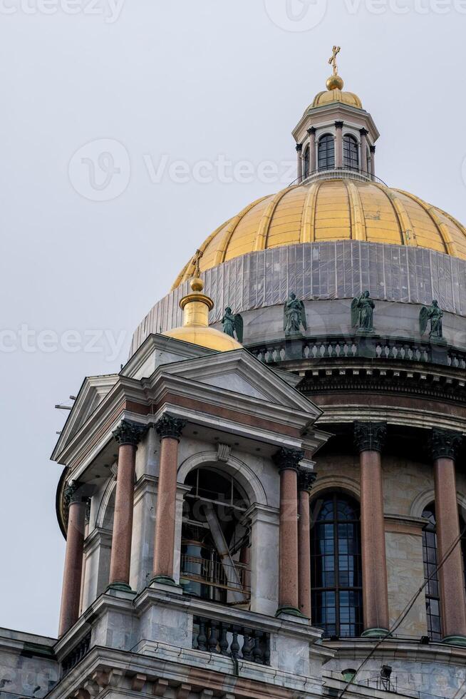 Views of St. Isaacs Cathedral With Its Iconic Golden Dome Against a Cloudy Sky in Saint Petersburg photo