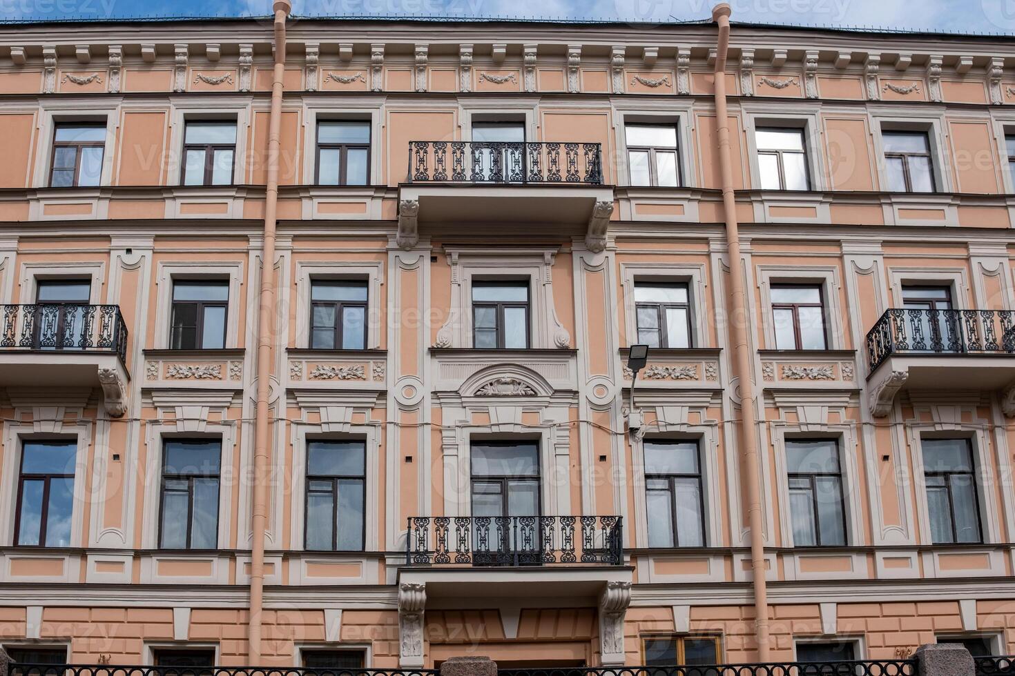 St. Petersburg Architecture Showcases a Beautifully Detailed Pastel Building With Balconies on a Clear Day photo