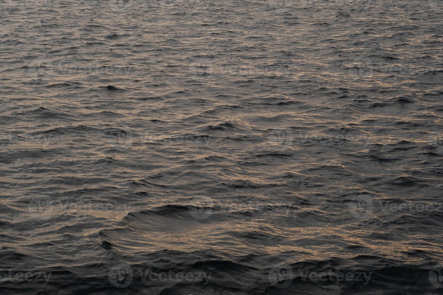 Bosphorus water at dusk reflecting soft light with gentle waves creating a serene atmosphere photo