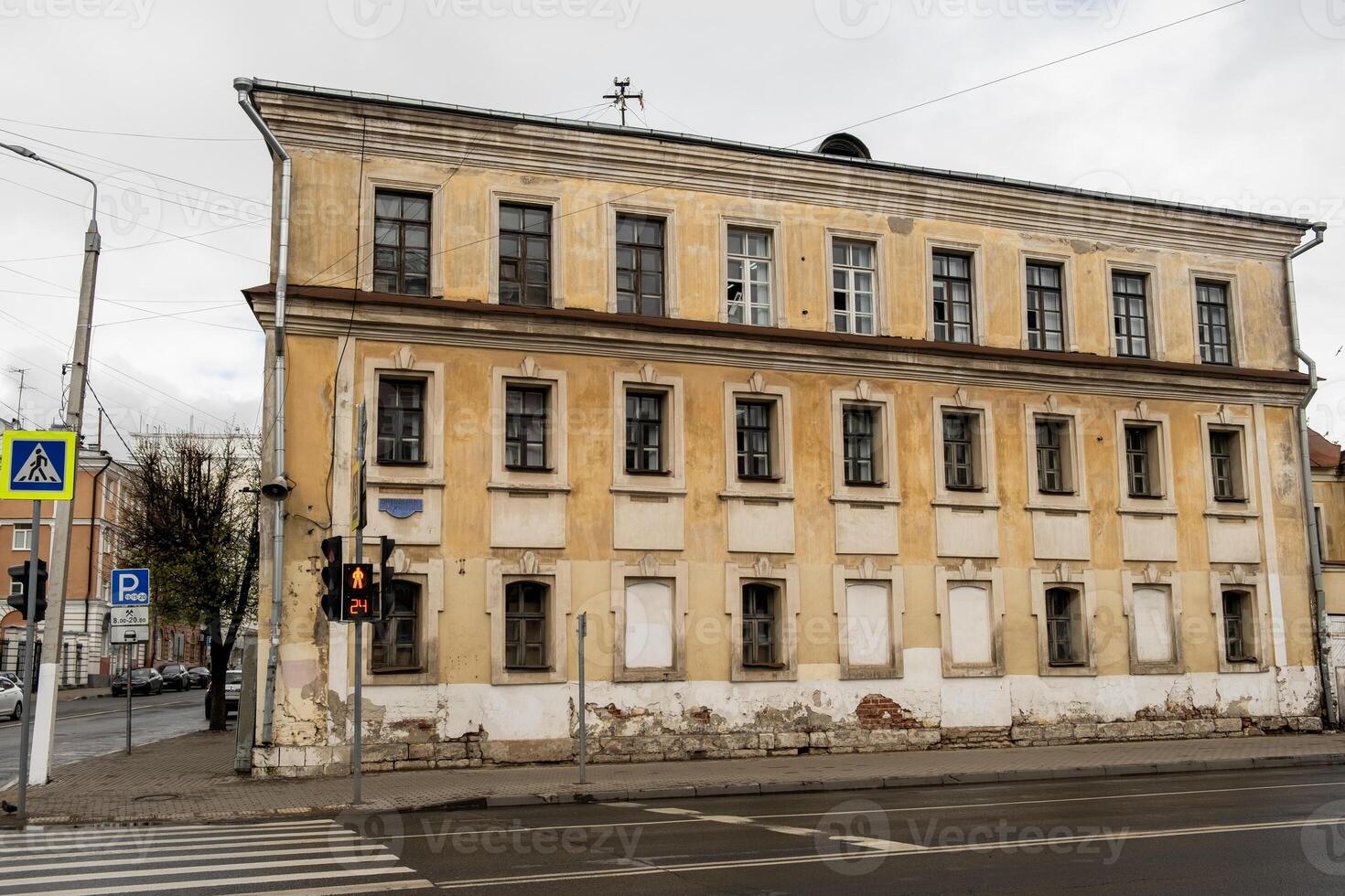 Old Building Facade with Traffic Light at Crosswalk photo