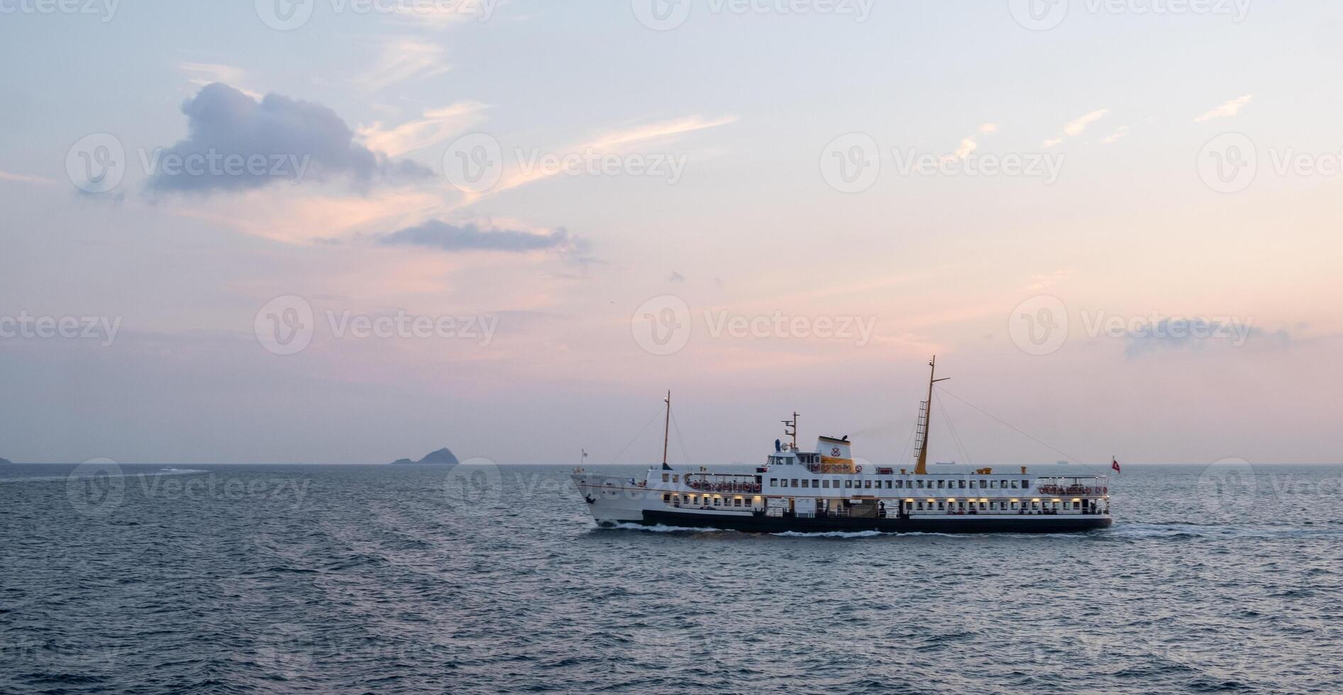 Bosphorus ferry sailing during sunset with a serene sky and calm waters photo