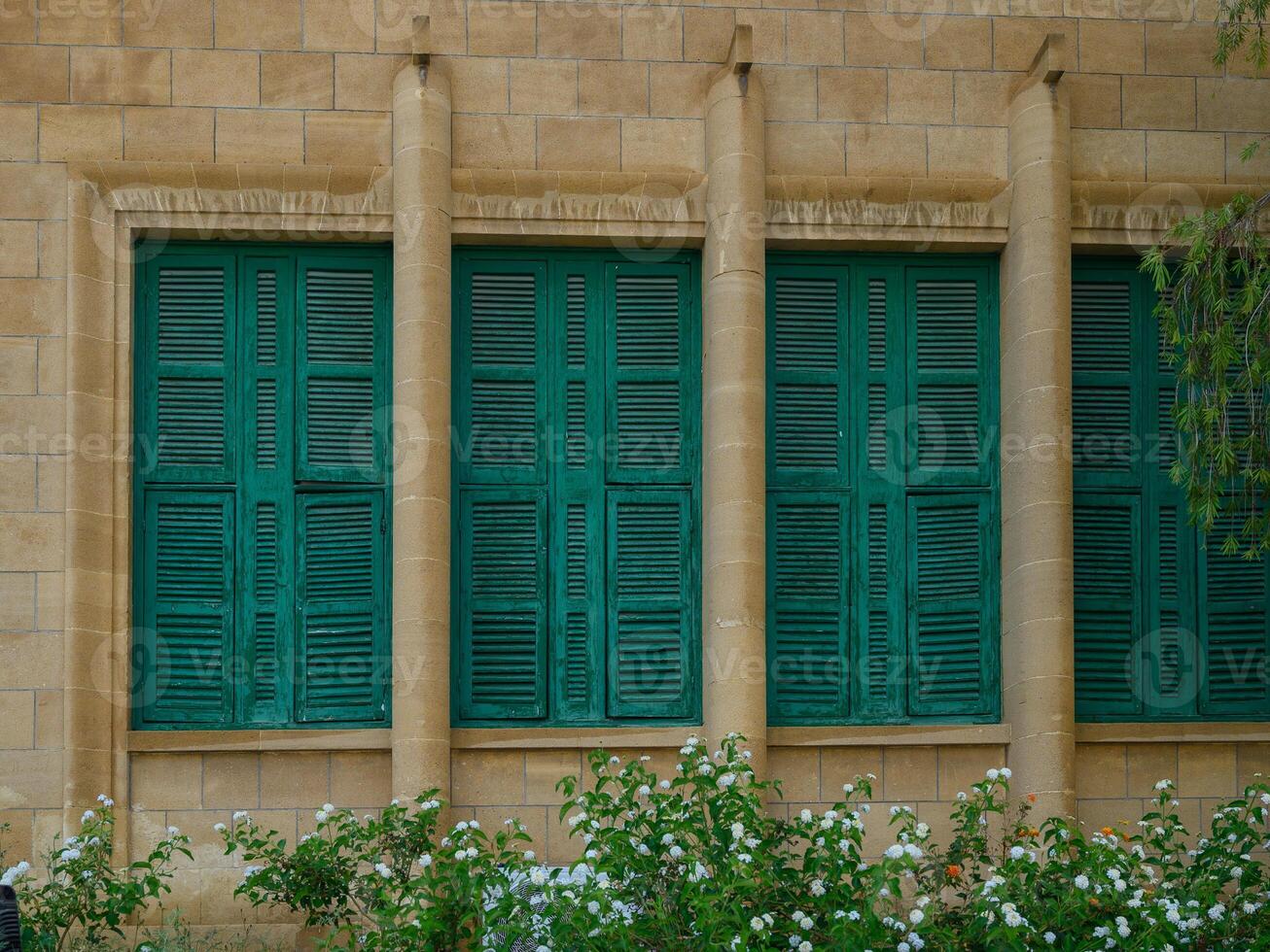 Old Stone Building with Green Shutters on Windows in Cyprus photo