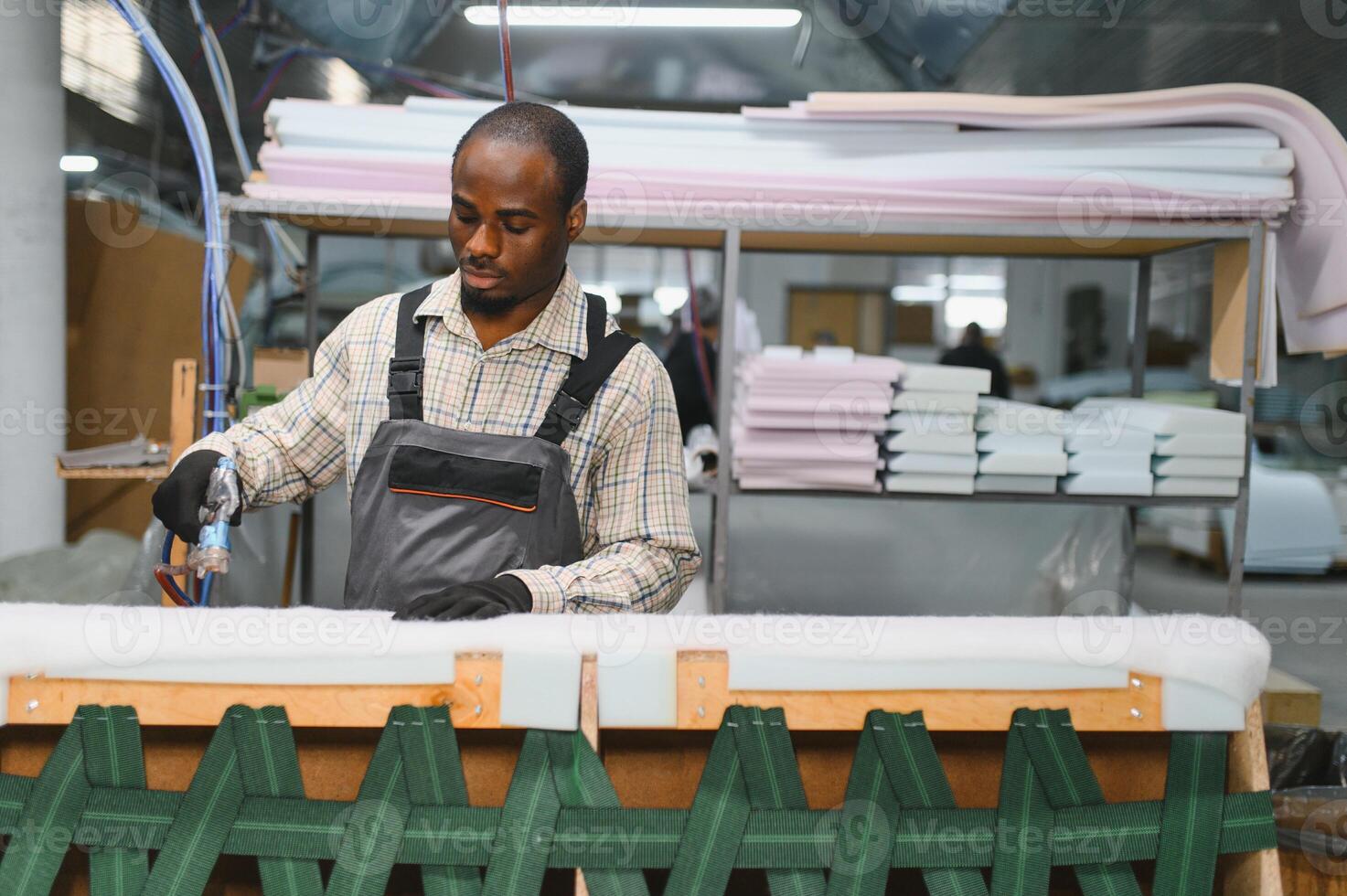 Furniture maker assembling sofa in factory photo