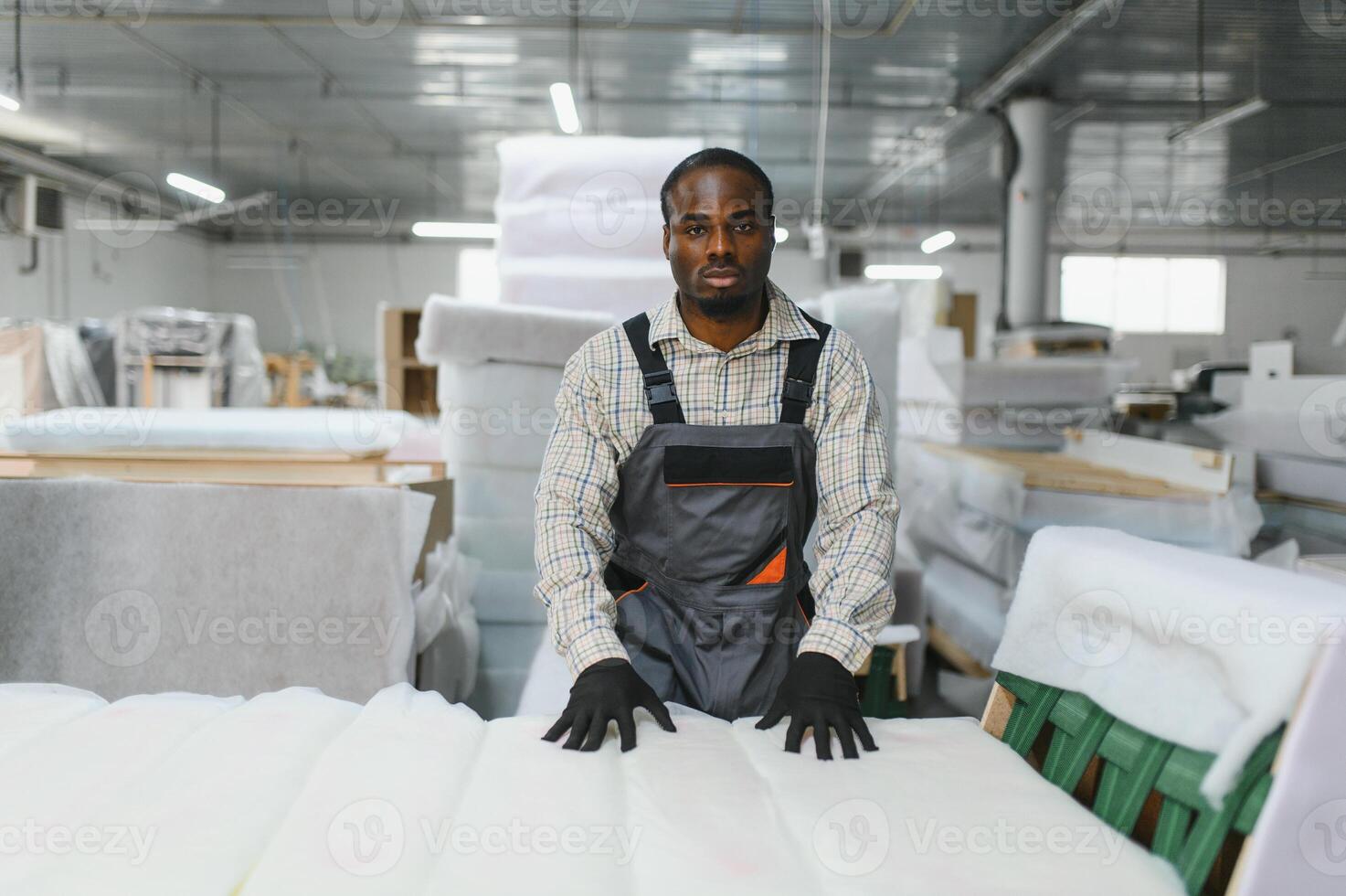 African american Furniture maker working on sofa manufacturing in factory photo
