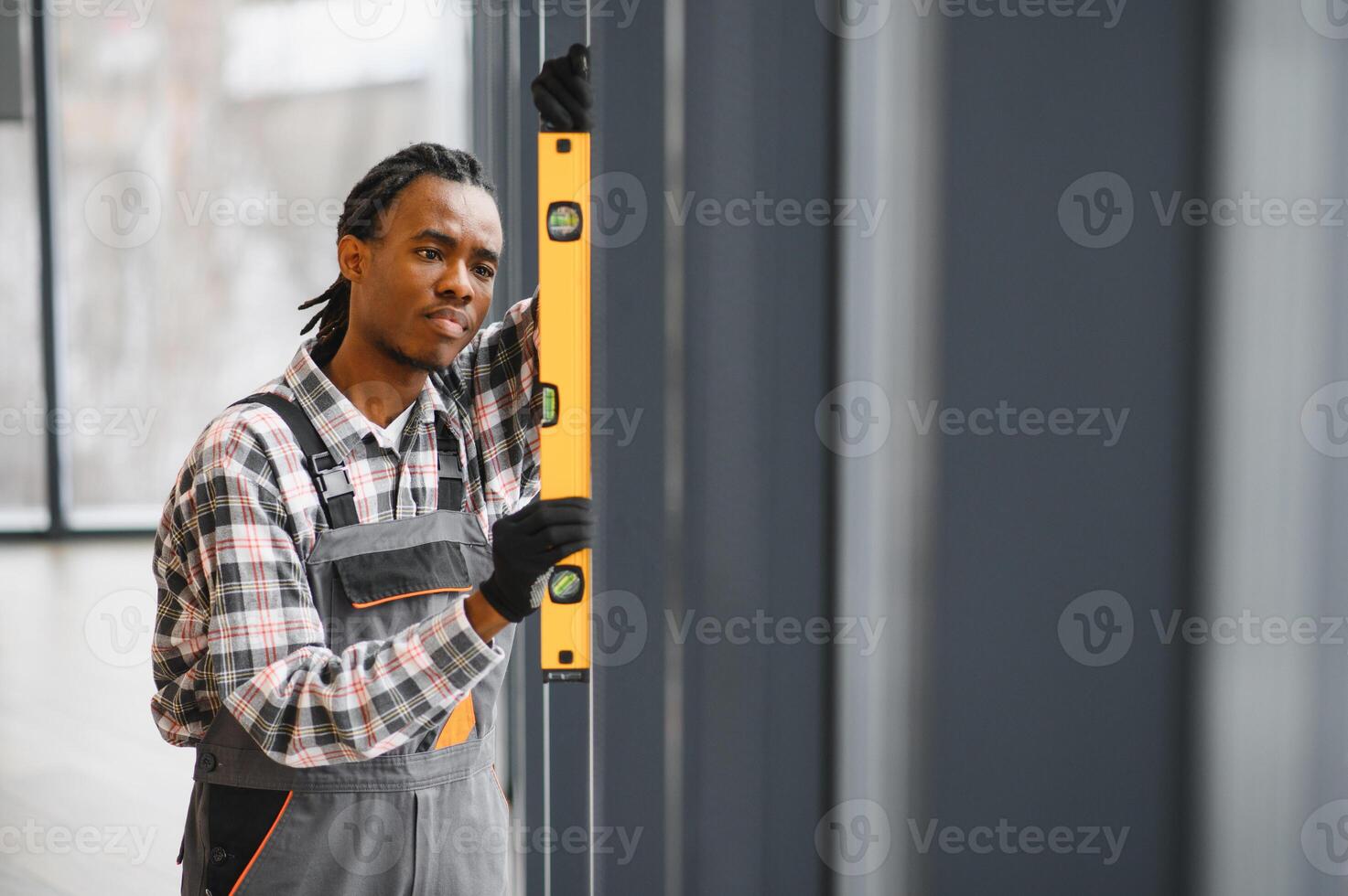 African American Skilled technician using level for precise installation photo