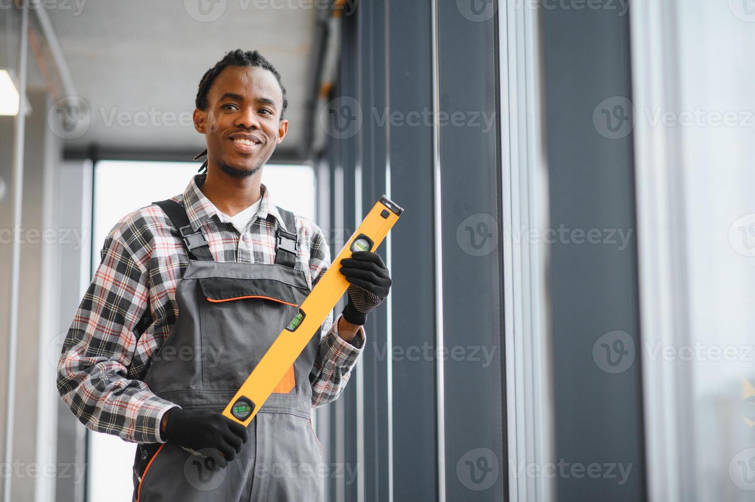 African American Skilled technician holding a level tool in industrial setting photo