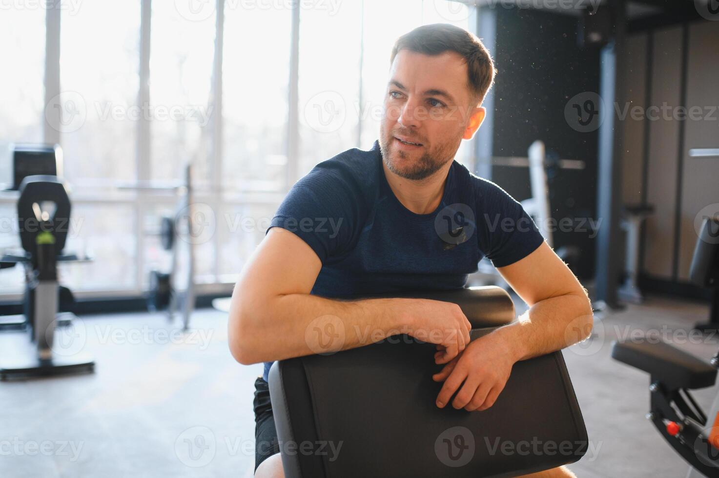 Patient resting during rehabilitation exercises in modern gym photo