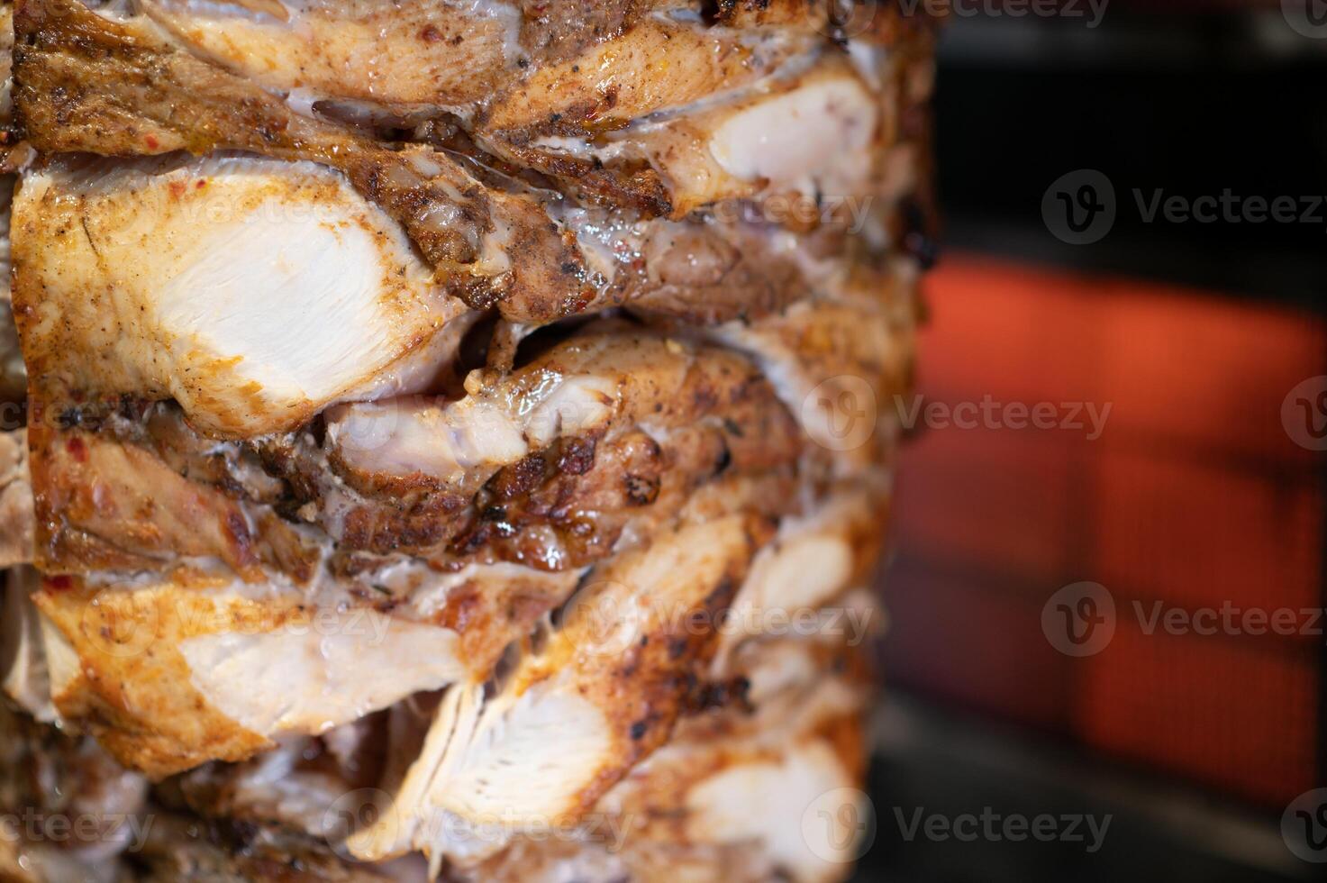 Juicy chicken shawarma rotating on a spit photo