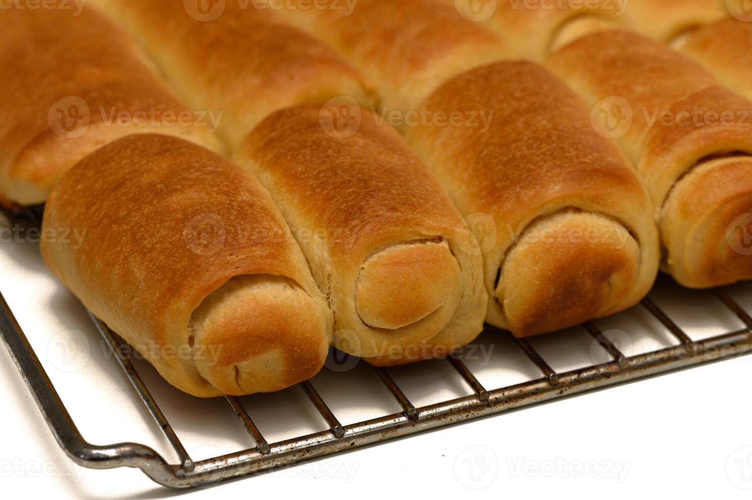 Golden Parker House Rolls Resting on Wire Rack After Baking photo