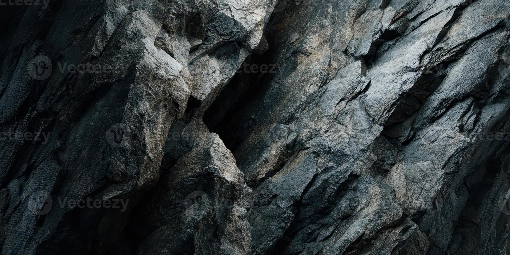 Close up texture of rugged natural rock surface in shadow photo