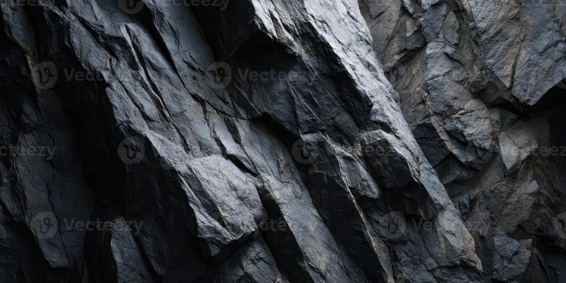 Close Up Texture of Dark Rocky Cliff Surface with Cracks photo