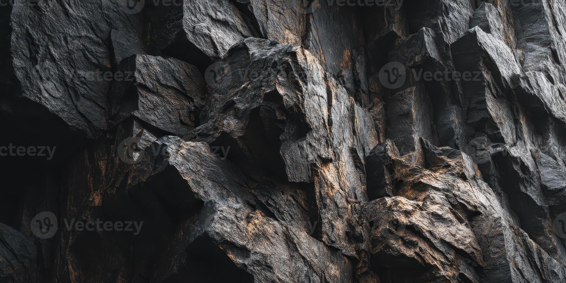 close up of textured rugged dark rocky cliff surface photo