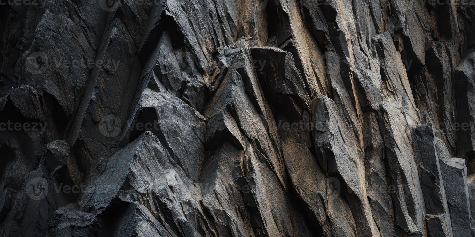 close up of rugged dark rocky cliff face texture photo
