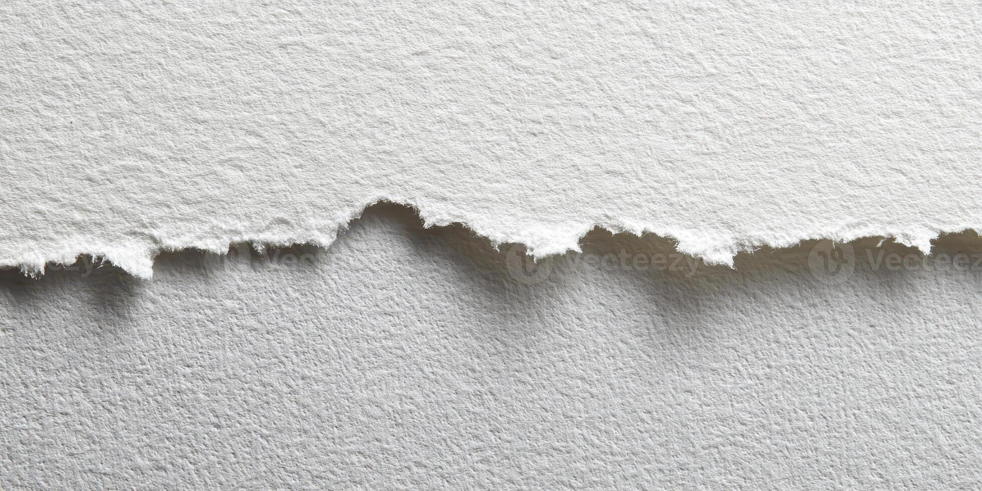 Close up of torn edge textured white paper surface photo