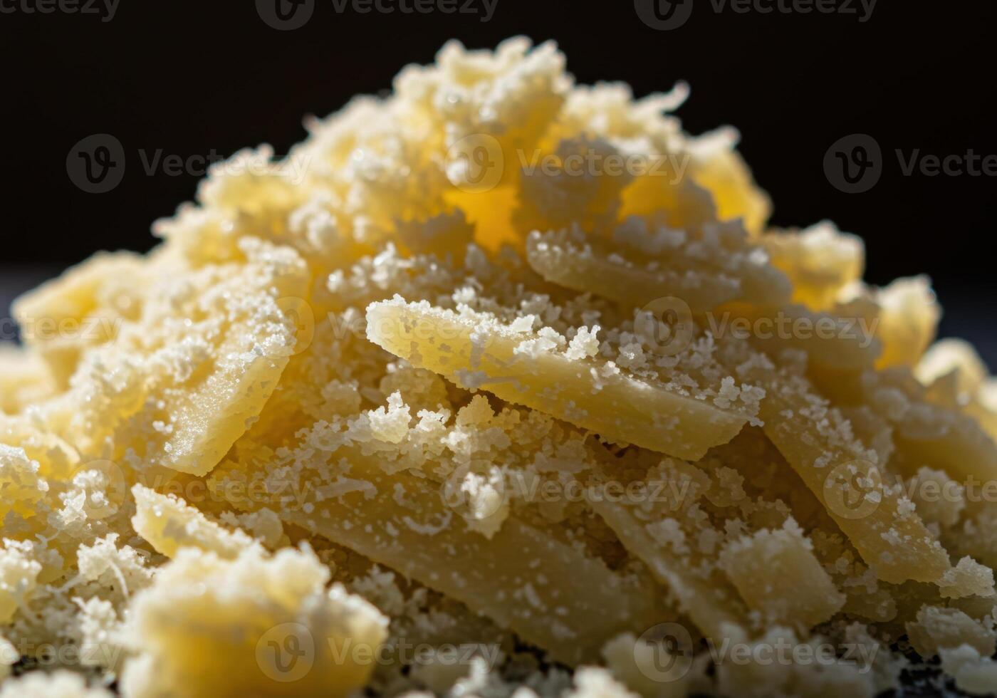 Freshly grated parmesan cheese, with a textured appearance, ready to be used. photo