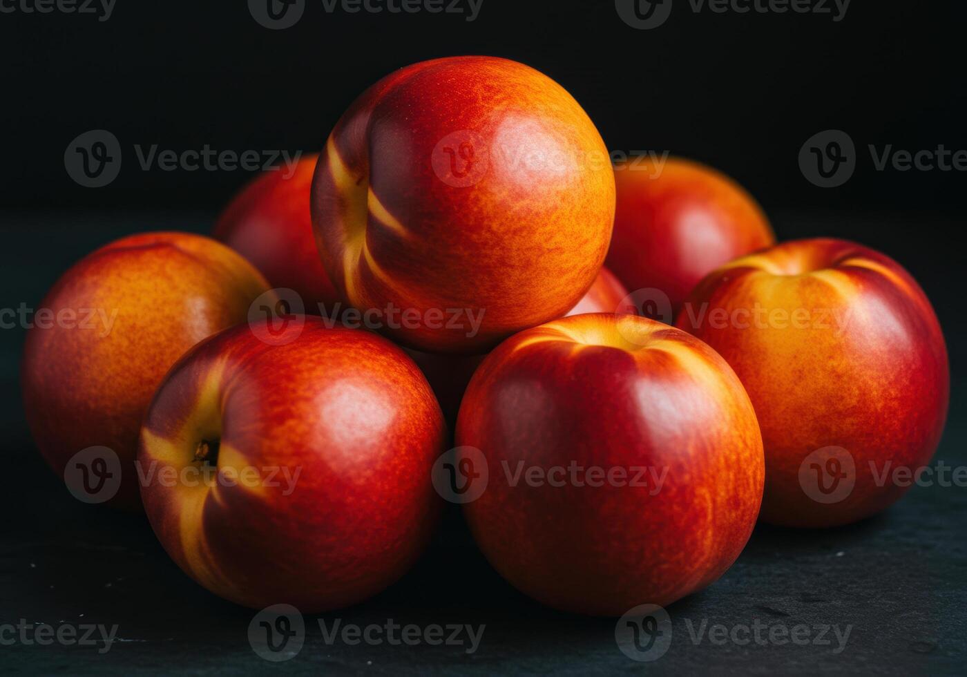 A close-up showcases a pile of fresh, ripe nectarines, bursting with vibrant colors. photo