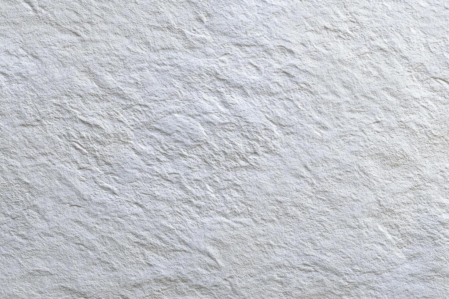 Textured white surface with subtle shadows reveals intricate details, creating a cool and calming photo