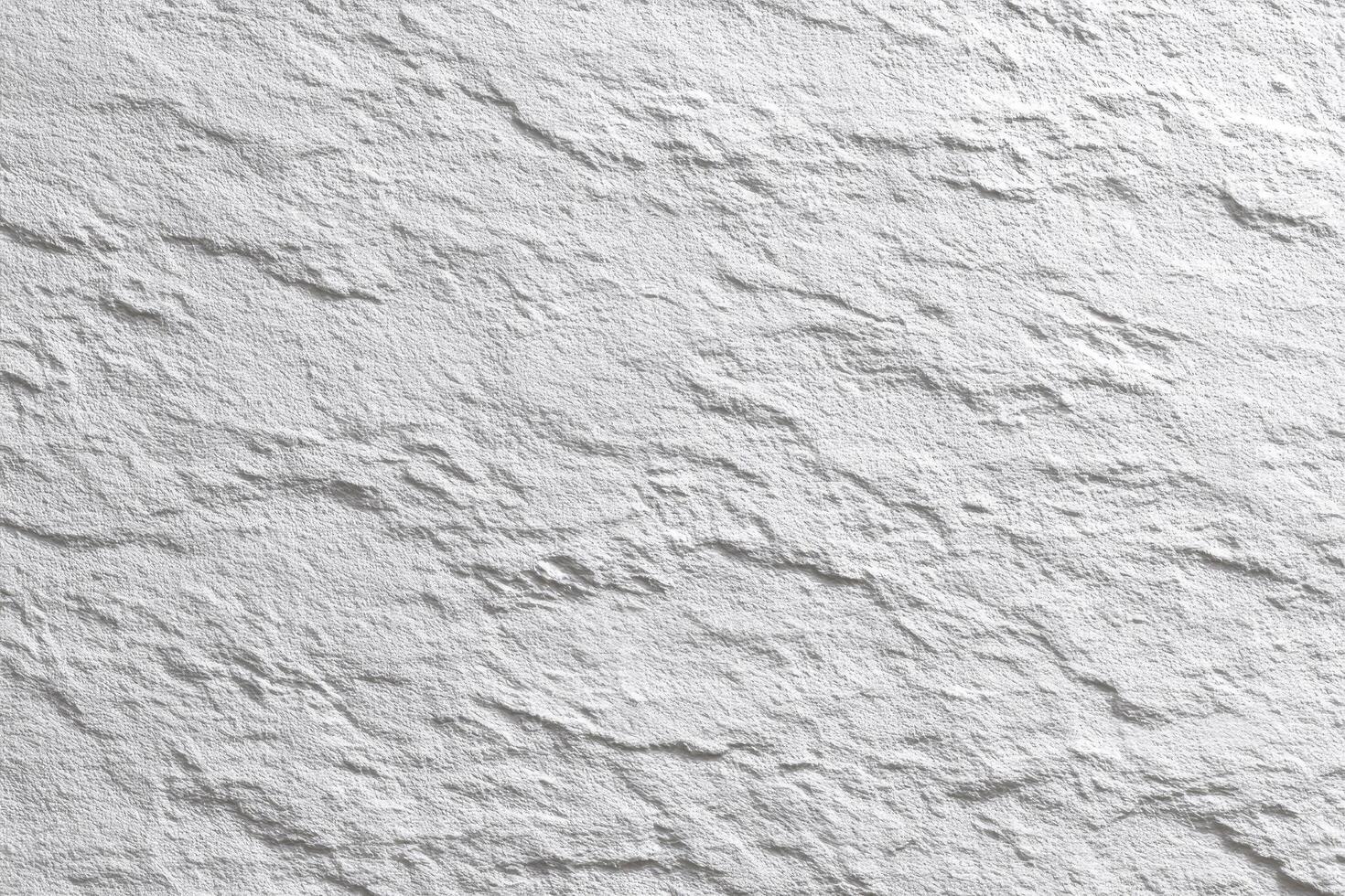 Detailed texture of rough white wall with subtle shadows creating depth and organic, natural photo