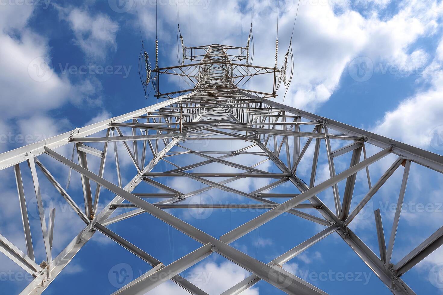 A high voltage tower with clouds in the background photo