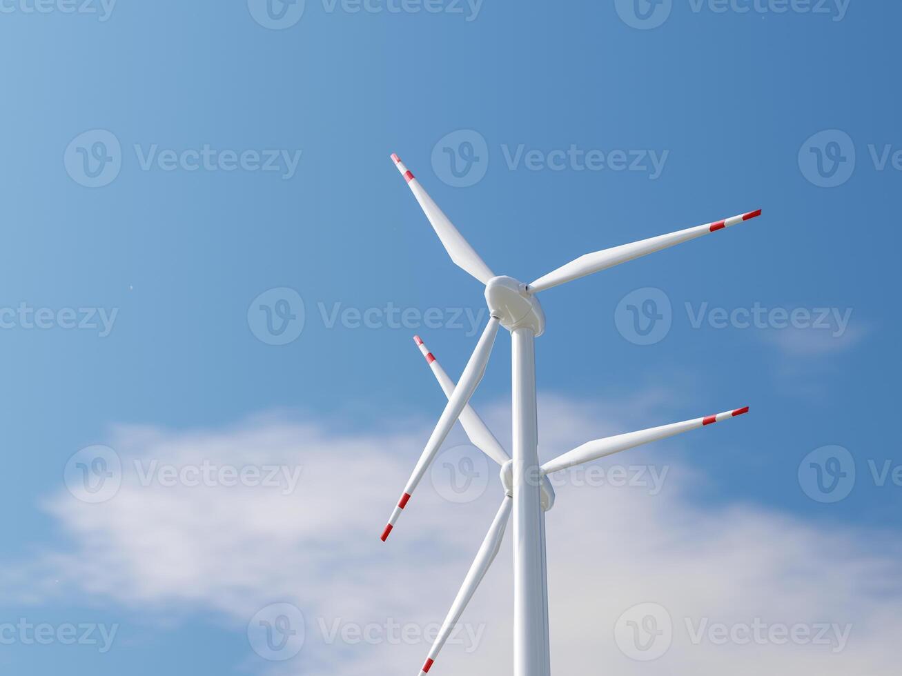 Low-angle view of a wind turbine with red-tipped blades in the sky. photo