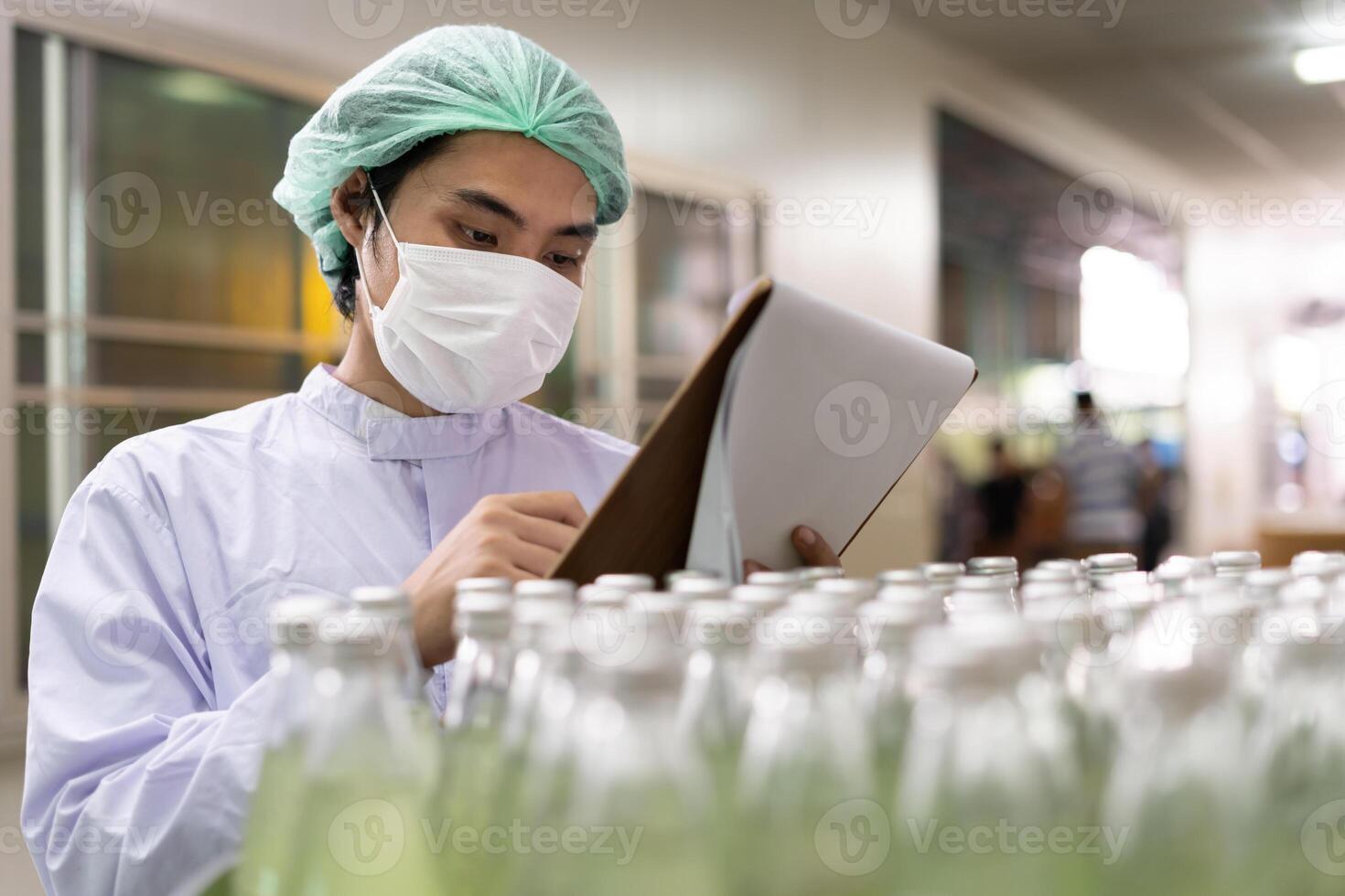 food or beverages technician inspection about quality control food or beverages before send product to the customer. Production leader recheck ingredient and productivity. photo