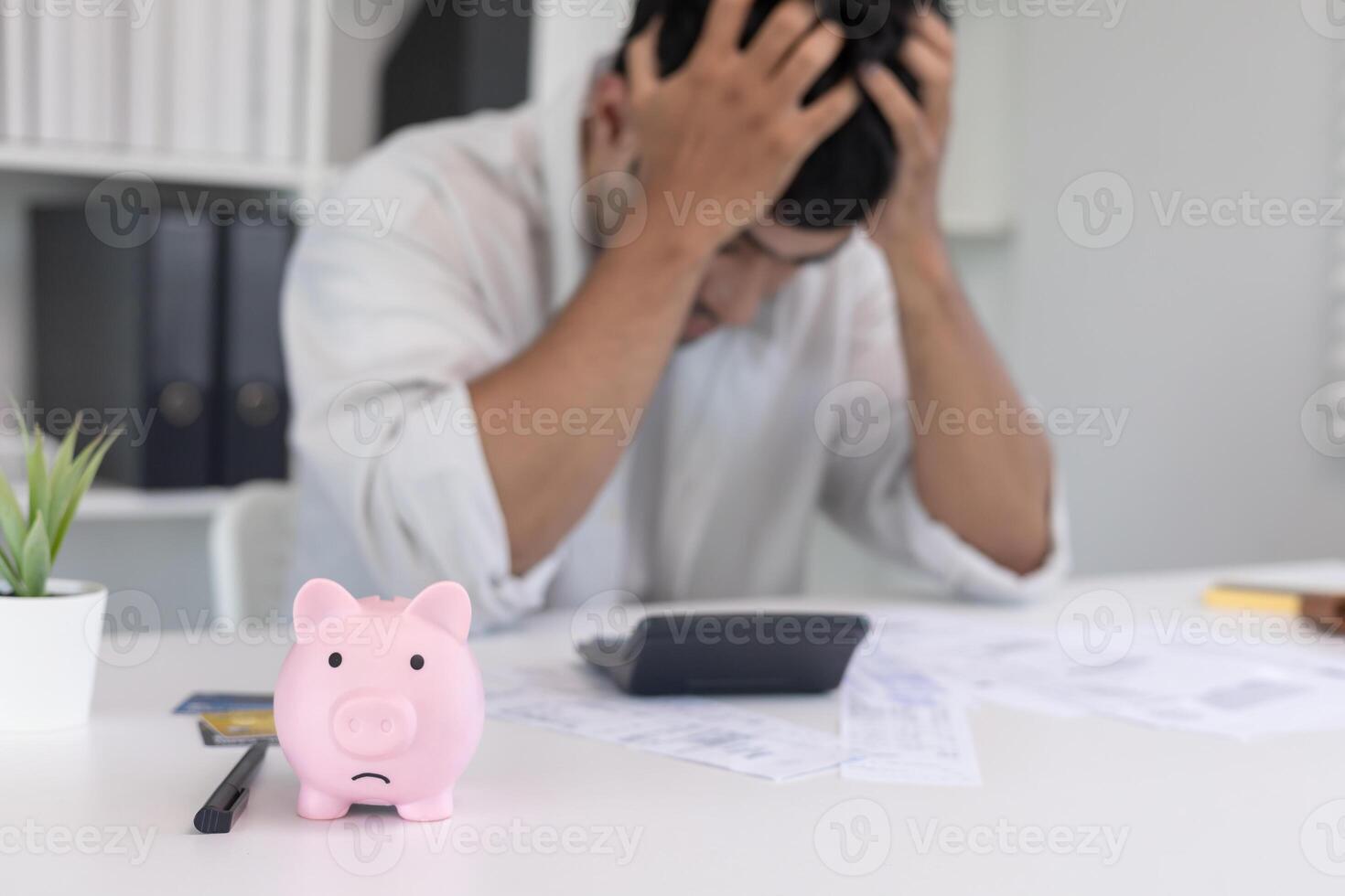 Stressed and headache man with large bills or invoices no money to pay to expenses and credit card debt. shortage, Financial problem, bankruptcy, mortgage, loan, bankrupt empty wallet photo