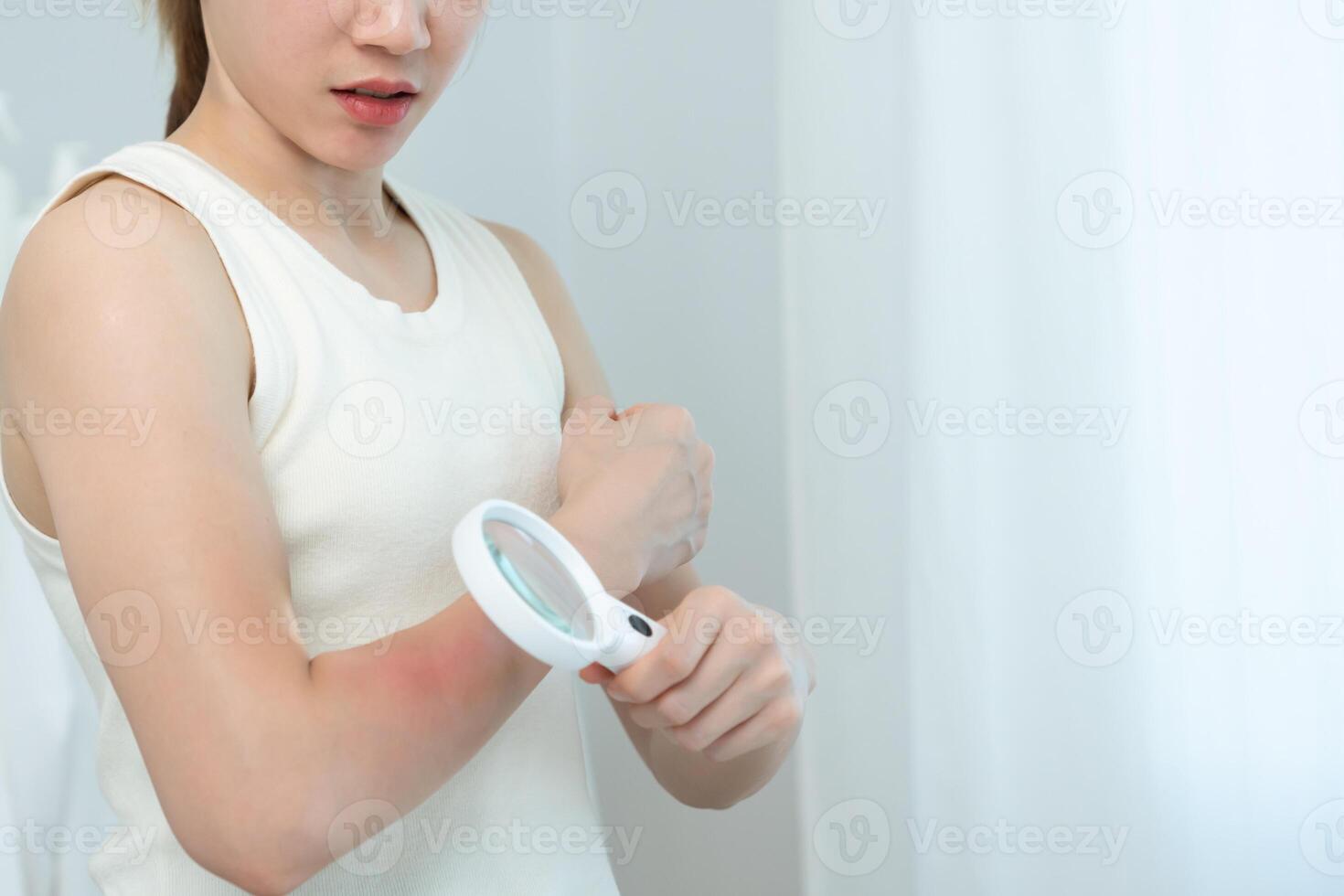 problem and beauty. asian woman use magnifying glass look itchy skin from skin allergic, shocked, steroid allergy, sensitive, chemical allergy, rash, insect bites, Seborrheic Dermatitis. photo