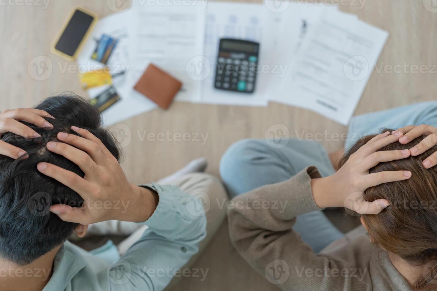 Stressed and headache couple with large bills or invoices no money to pay to expenses and credit card debt. shortage, Financial problems, mortgage, loan, bankruptcy, bankrupt, poor, empty wallet photo