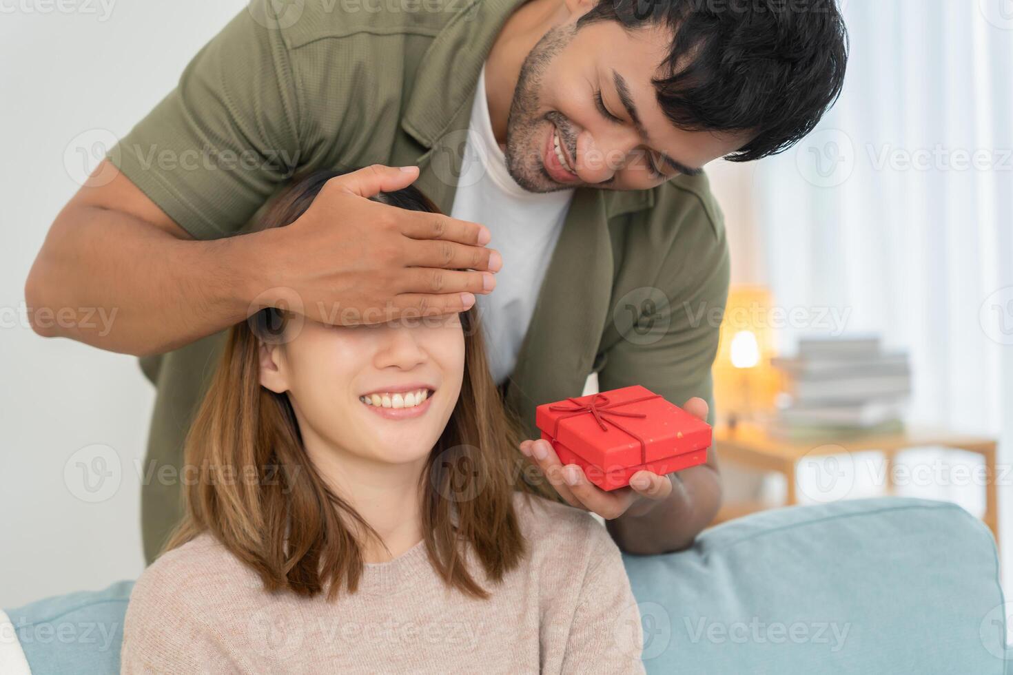 Happy husband close wife eye for surprise wife. cute girl excited gift box. birthday, Celebration, xmas, New year Festival, thank, Celebrate, Valentine's Day, Anniversary married photo