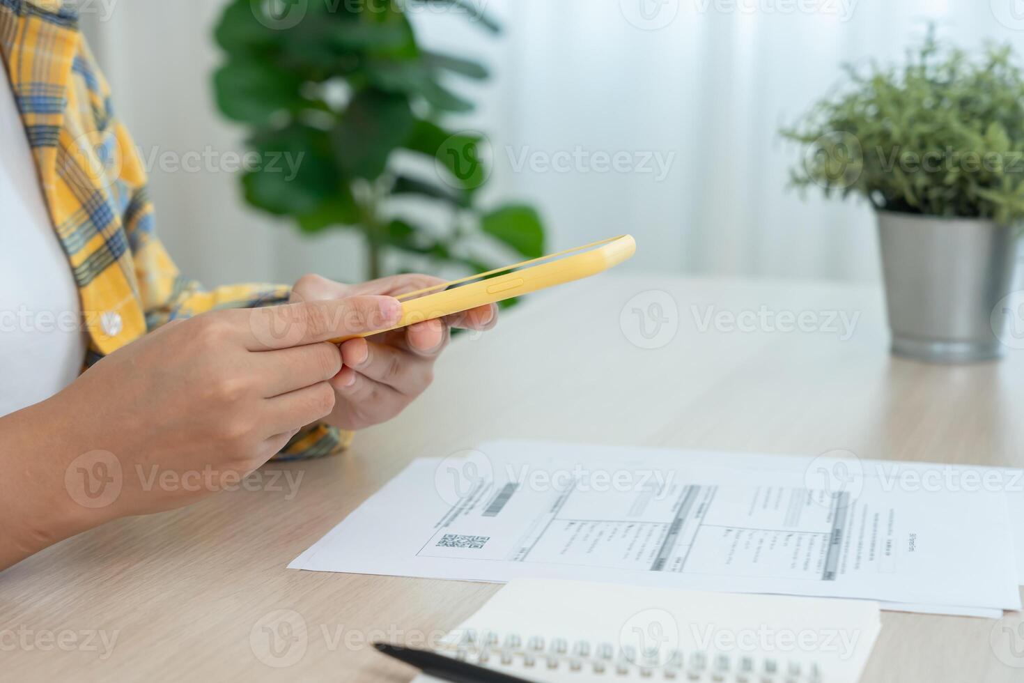 using phone to scan barcode or QR codes to pay credit card bill after receiving document invoice online. payment, receive, paying electricity, digital payments, technology, scanning photo