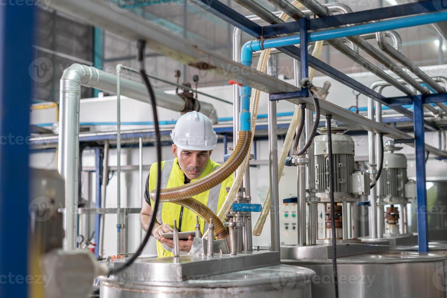 factory managers wearing safety helmet inspect the machines in the production line. Utility inspector check machine and test the system to meet the standard. machine, maintenance. photo