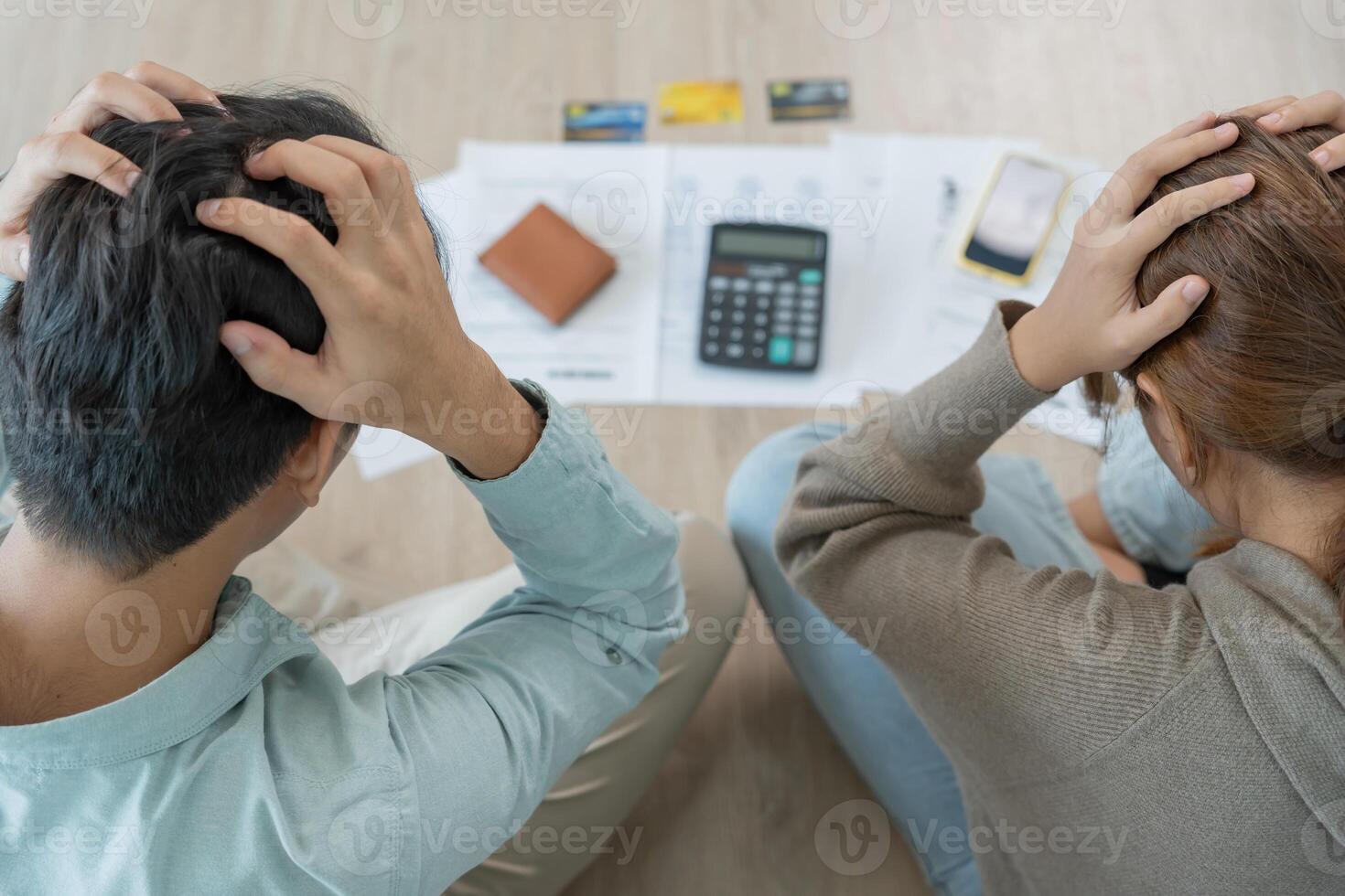 Stress and headache asian couple with large bills or invoices no money to pay to expenses and credit card debt. shortage, Financial problems, mortgage, loan, bankruptcy, bankrupt, poor, empty wallet photo