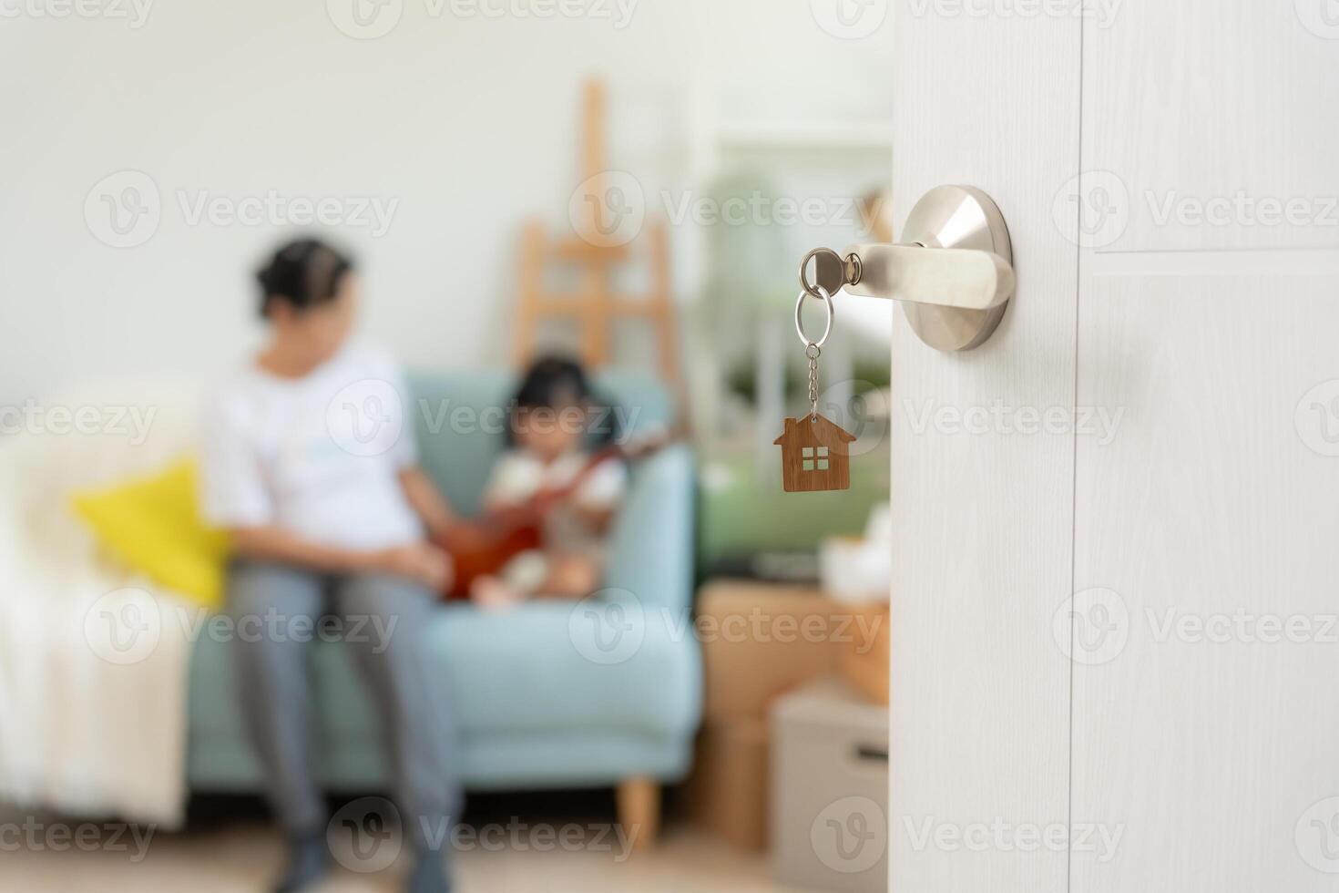 Moving house relocation and Open the door found Family smile and play on new house, inside the room was a cardboard box contain personal belongings and furniture. move in the new apartment or home. photo