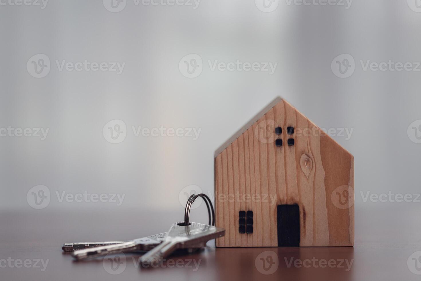 Wooden House Model with Keys. Concept of Homeownership and Real Estate. photo