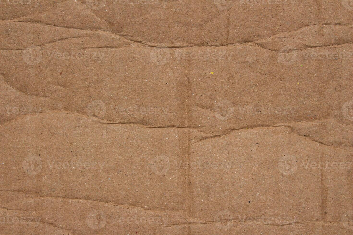 Abstract creased brown cardboard paper texture background design element photo