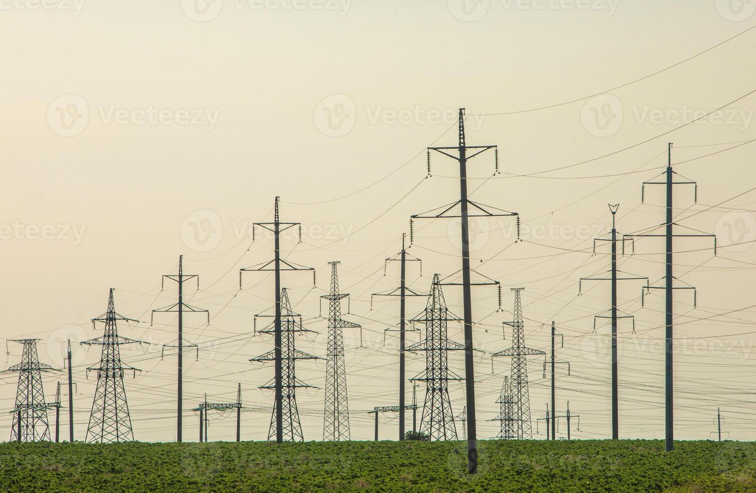 High-voltage power line in the field. Electricity pylons in the evening. Electric tower. Power transmission lines. energy security and clean energy. photo