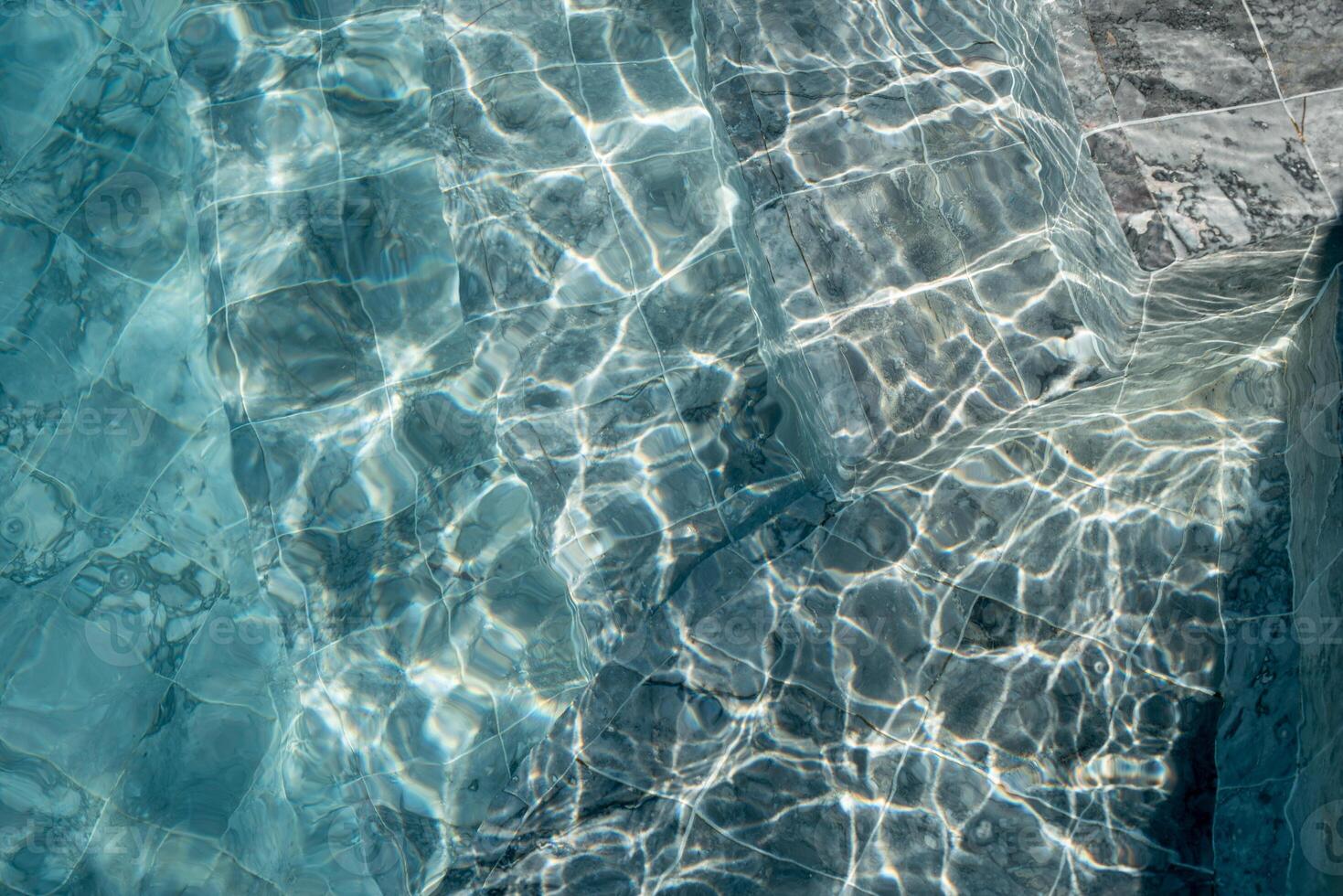 The blue tiles texture in the swimming pool. photo